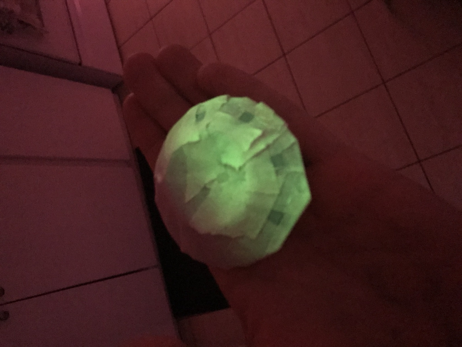 A mini UFO glowing in the dark