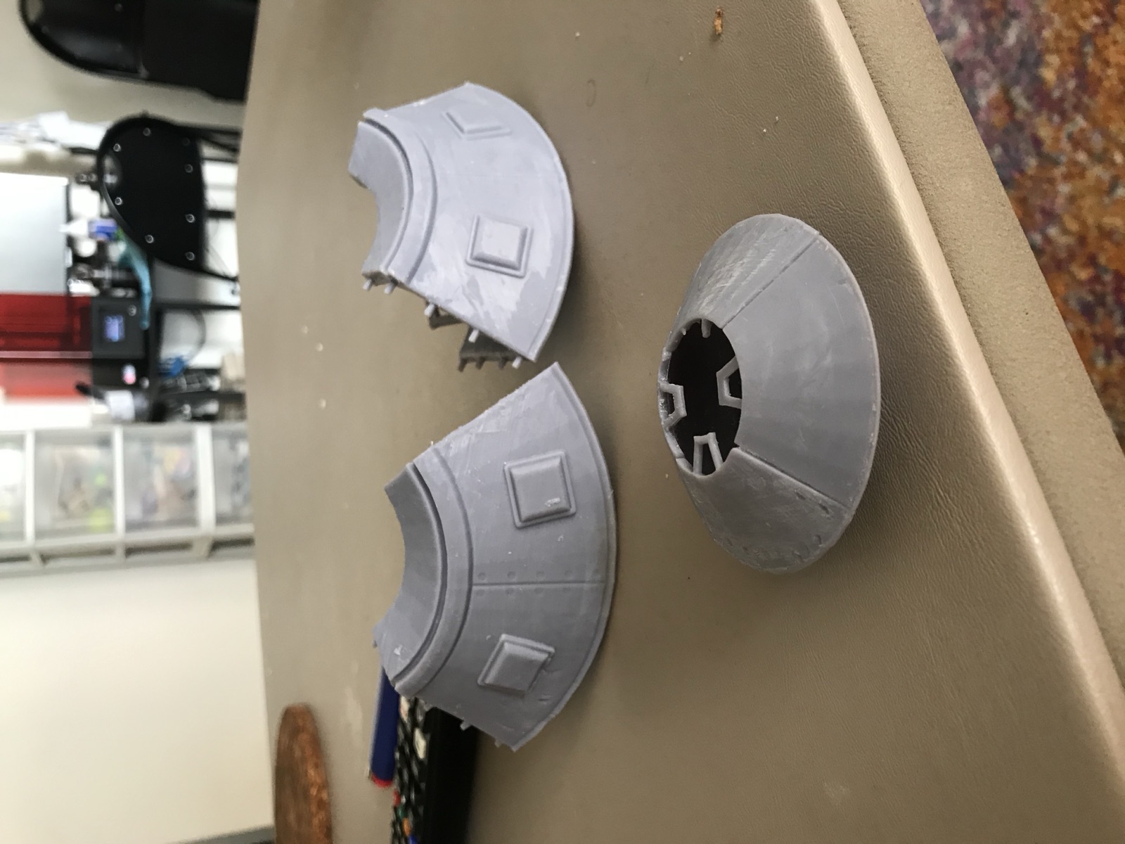 Full-size hull pieces next to the small resin test model